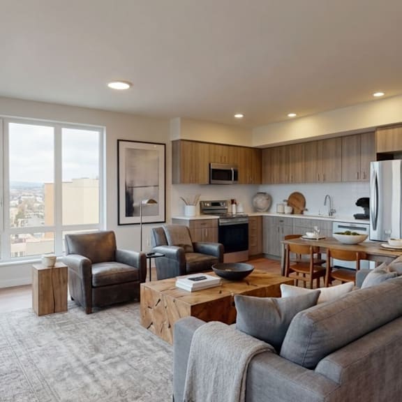a modern living room with a grey couch and a wooden coffee table.