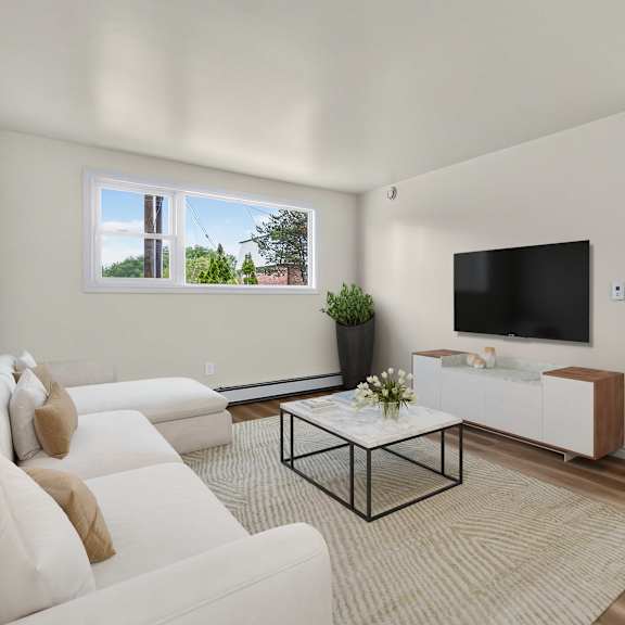 a living room with a white couch and a black coffee table.