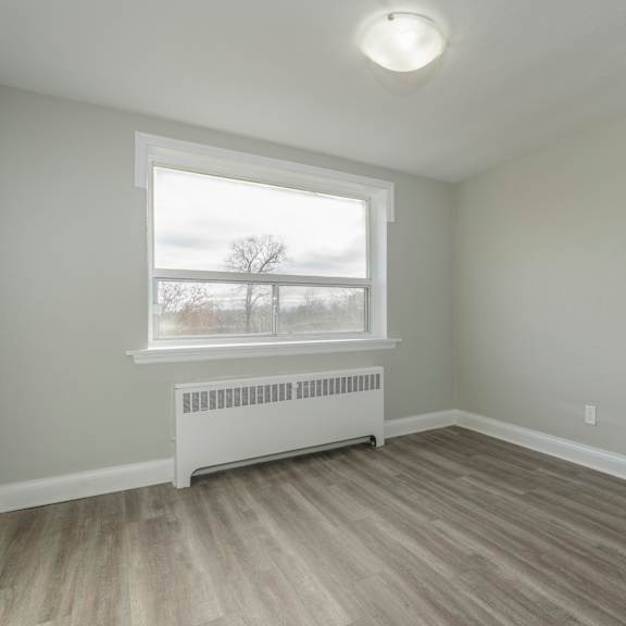 a room with a window and a radiator on the floor.