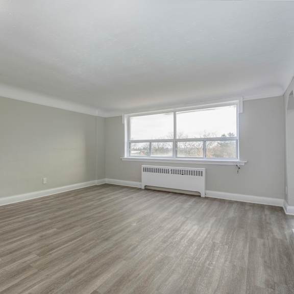 a room with a window and a radiator on the wall.