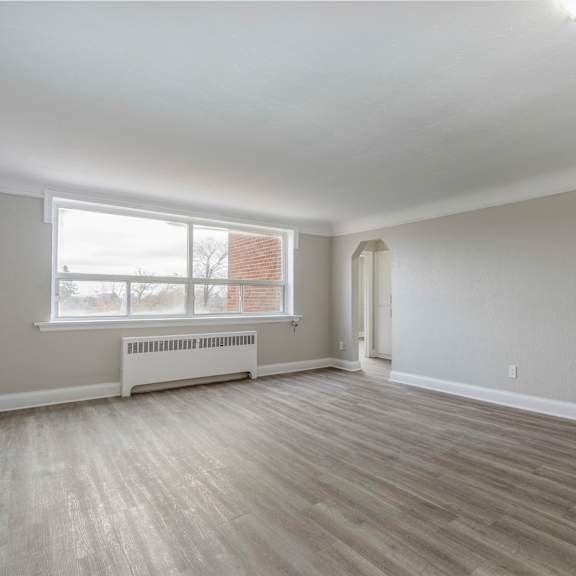 a room with a window and a radiator on the wall.