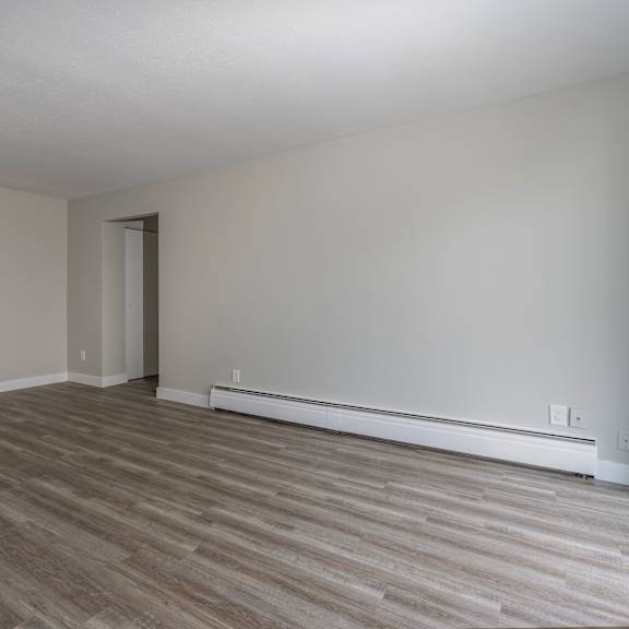 a room with a wooden floor and a door.