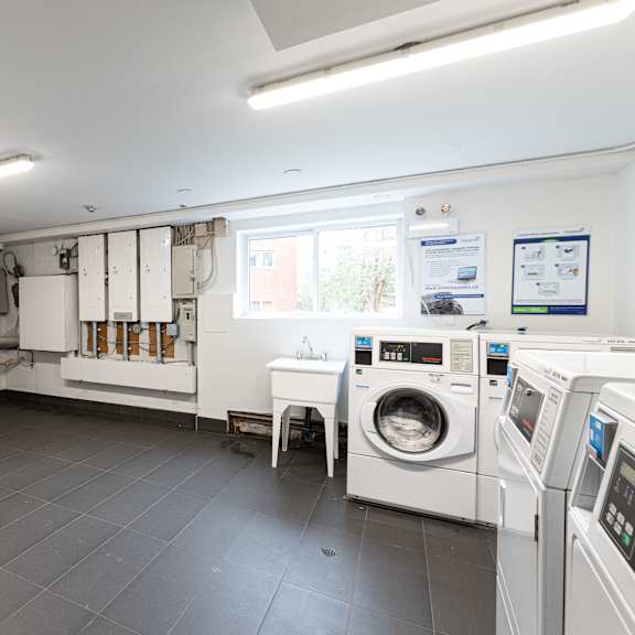 a clean, well-lit laundry room with a washing machine and dryer.