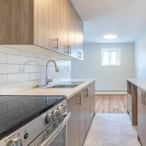 a kitchen with a stove top oven and a refrigerator.