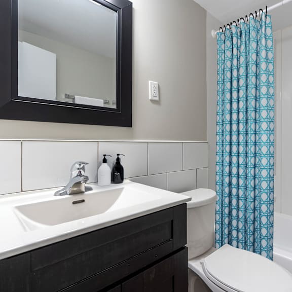 a white toilet sits next to a sink in a bathroom.