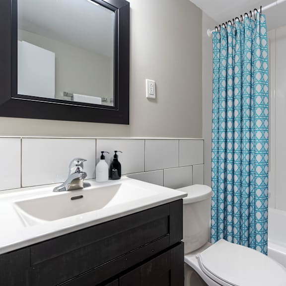 a white toilet sits next to a sink in a bathroom.