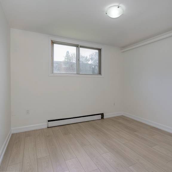 a room with a window and a radiator on the floor.
