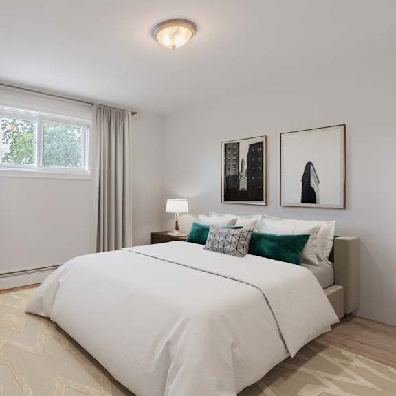 a bedroom with a large bed and a window with curtains.