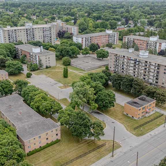 a view of a residential area with multiple buildings and trees.