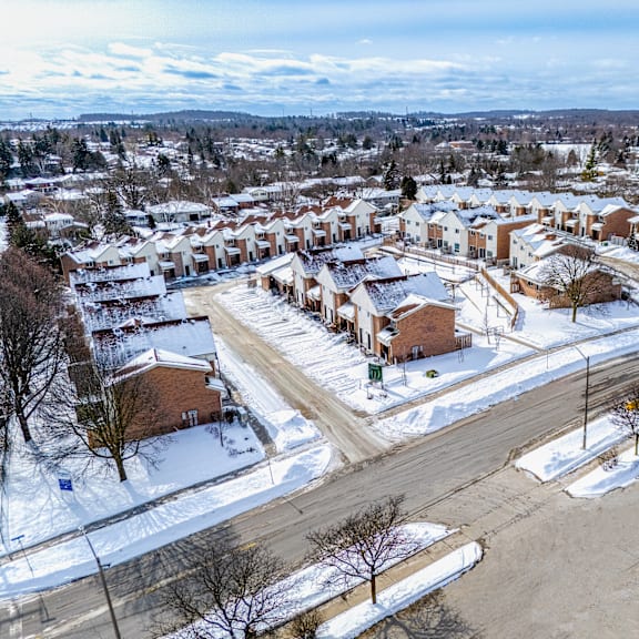 a snowy residential area with houses and roads.