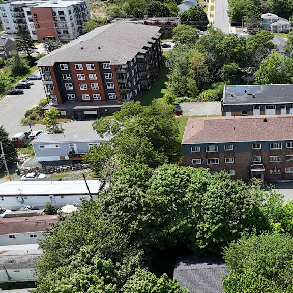 a bird's eye view of a residential area with houses and trees.