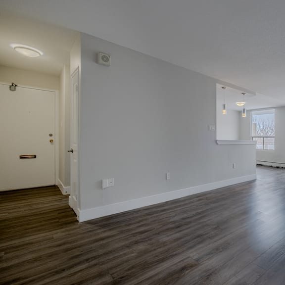 a room with wooden floors and white walls.