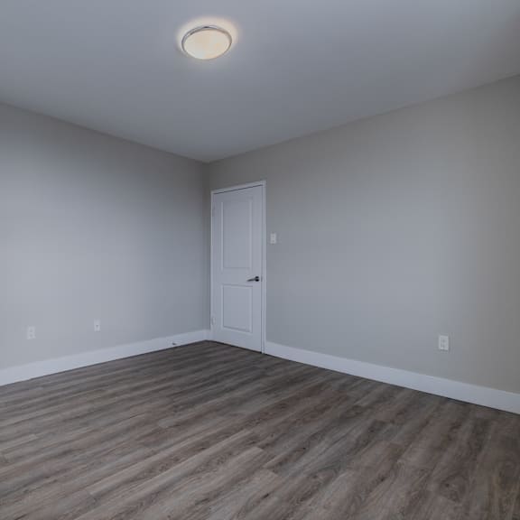 a room with two doors and a light on the ceiling.