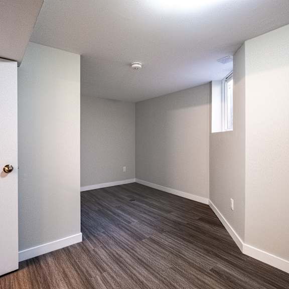 a room with a white door and a window with blinds.