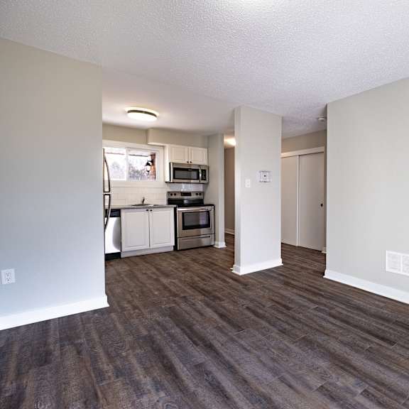 a room with wooden floors and white walls.