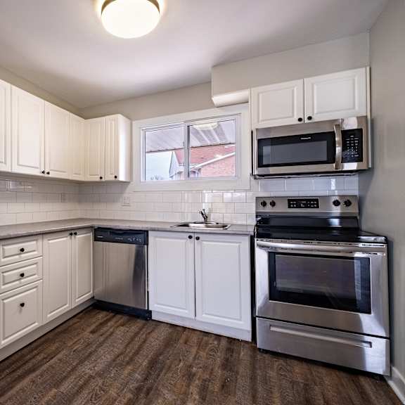 a kitchen with a stainless steel refrigerator and oven.