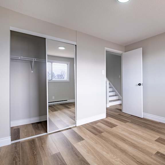 a room with a wooden floor and a white door.