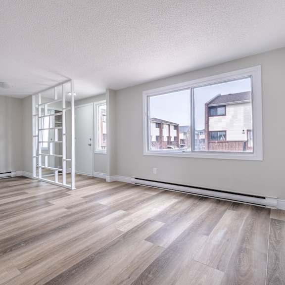 a room with wooden flooring and a ladder in it.
