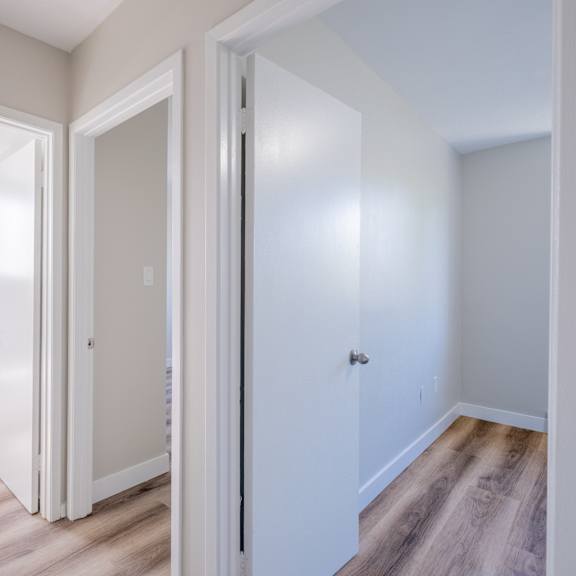 a white door is open to a bathroom.