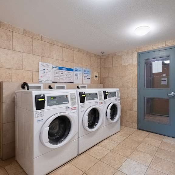 a row of washing machines in a public laundromat.