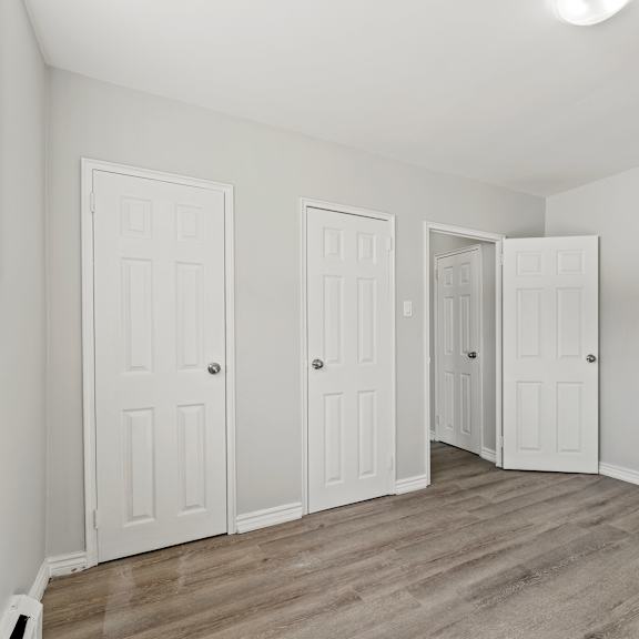 a room with four doors and a light on the ceiling.