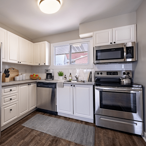 a kitchen with a stainless steel refrigerator and oven.
