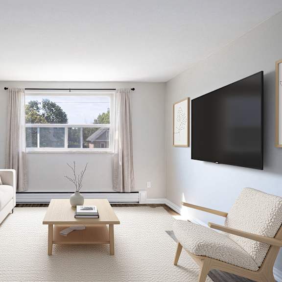 a living room with a white couch, a coffee table, and a chair.