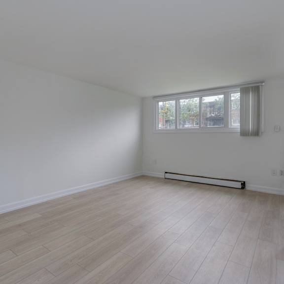 a room with a window and a radiator on the wall.