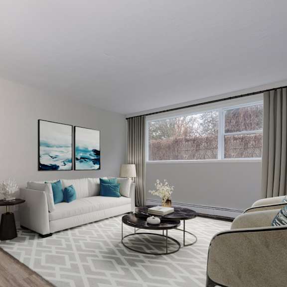 a living room with a white couch and a painting on the wall.