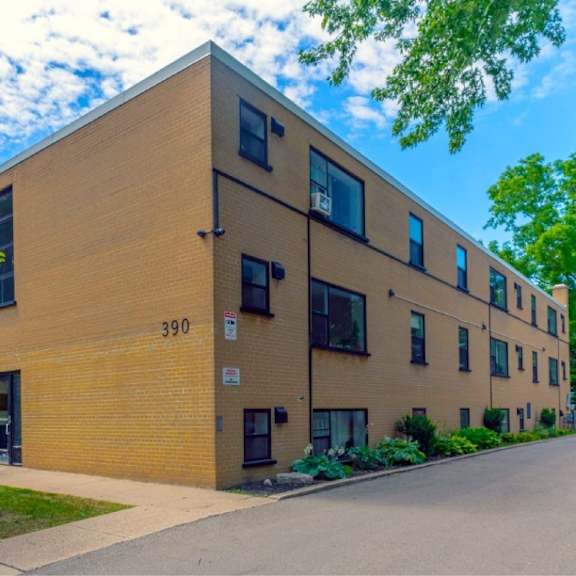 a building with the number 390 on it is surrounded by greenery.