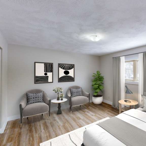 a bedroom with a large bed, two chairs, a table, and three pictures on the wall.