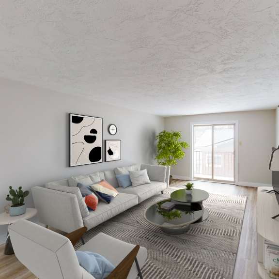 a living room with a grey couch, a small table, a plant, and a painting on the wall.