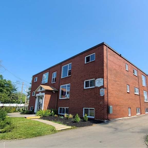 a red brick building with a clear blue sky in the background.