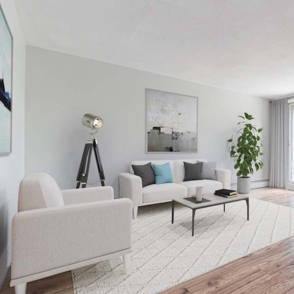 a living room with a white sofa, a white chair, a coffee table, a potted plant, and a painting on the wall.