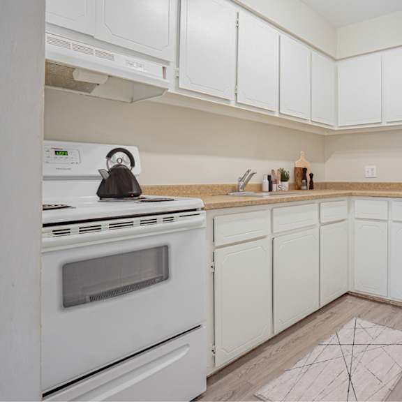 a kitchen with white appliances and cabinets.