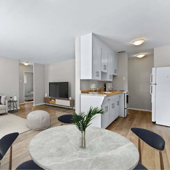 a modern living room with a grey marble table and black chairs.