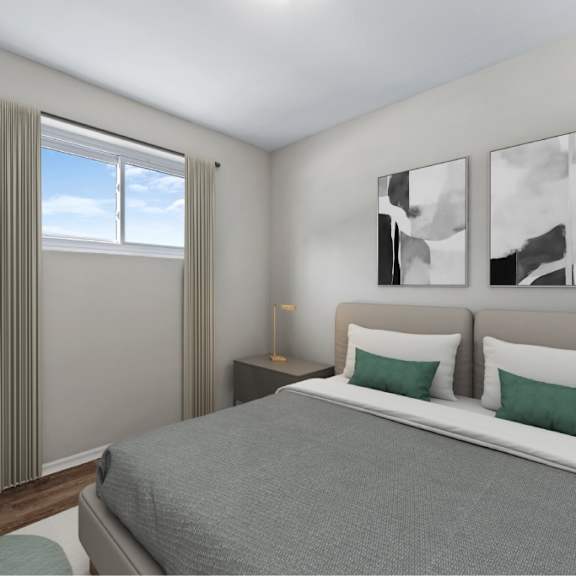 a bedroom with a large bed, a potted plant, and two framed pictures on the wall.