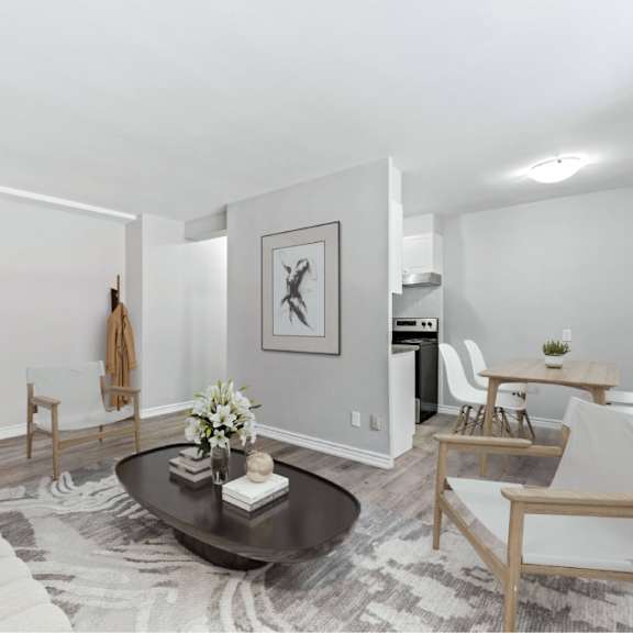 a modern living room with a white sofa, a coffee table, and a rug.