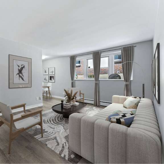 a living room with a grey sofa and a wooden chair.