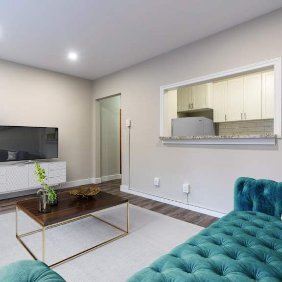 a living room with a white cabinet, a blue couch, and a mirror on the wall.