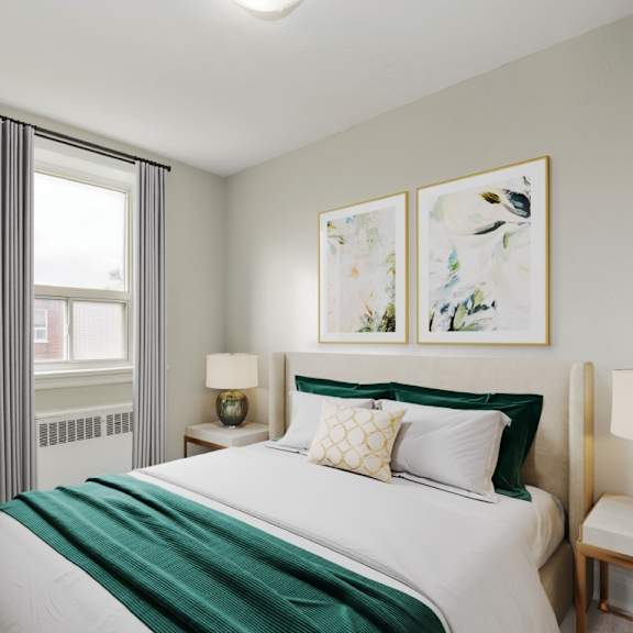 a bedroom with a large bed and two framed pictures on the wall.