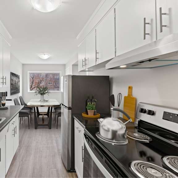 a modern kitchen with a stove, sink, and countertop.