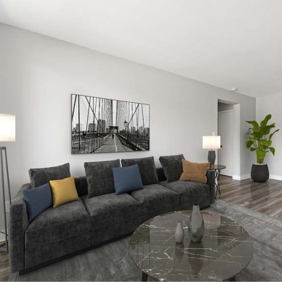 a modern living room with a grey sofa, a coffee table, and a television.