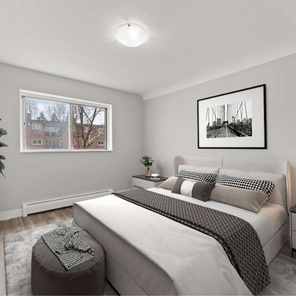a bedroom with a large bed, a window, and a painting on the wall.