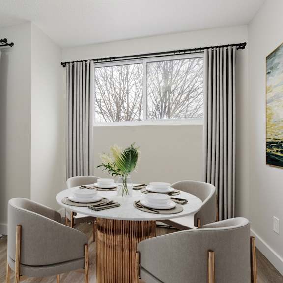a dining room with a table set for four.