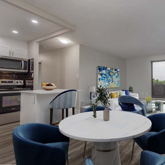 a modern dining room with a white table and blue chairs.