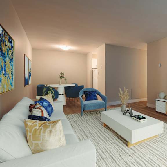 a living room with a white couch, a blue chair, a white coffee table, and a flat screen tv mounted on the wall.