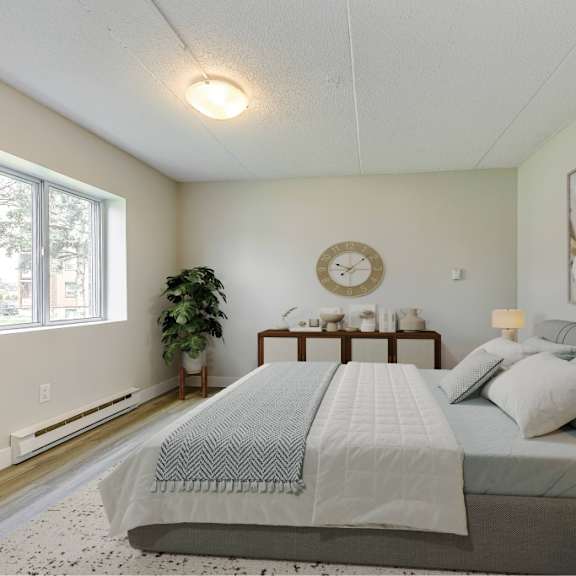 a bedroom with a large bed and a clock on the wall.