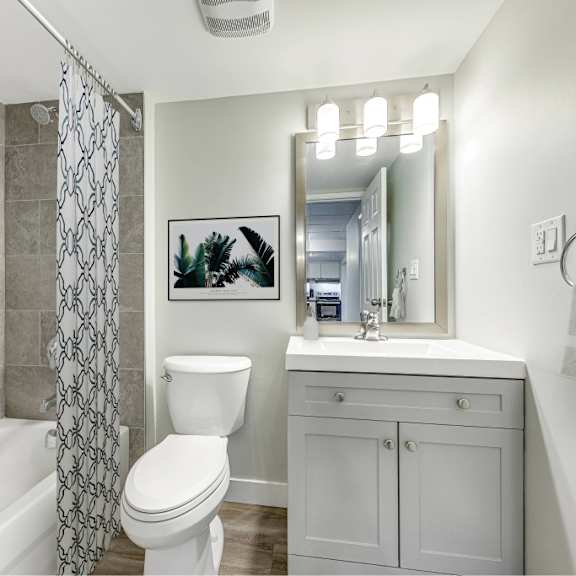 a bathroom with a white toilet, a white sink, and a white bathtub.