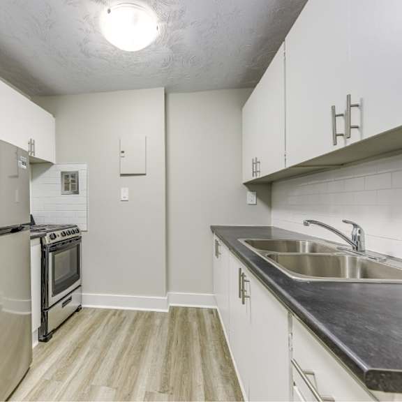 a kitchen with a stainless steel refrigerator and oven.